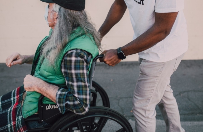 person being pushed in wheelchair