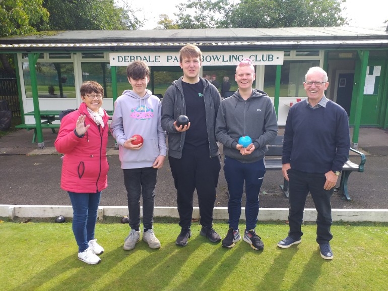 Group of young and adult carers playing bowls