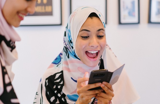 Girl smiling and looking at her phone