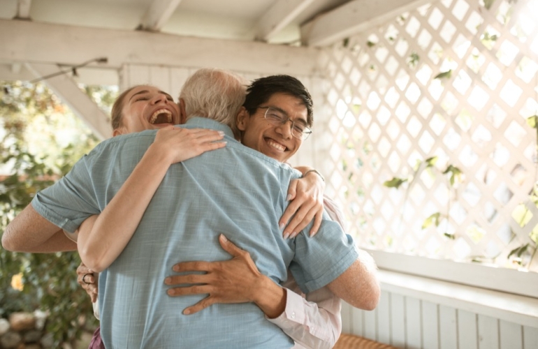 Three people having a hug