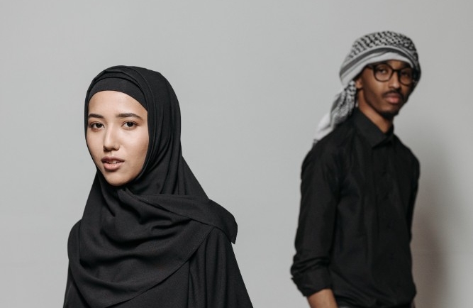 Woman wearing hijab and man wearing keffiyeh