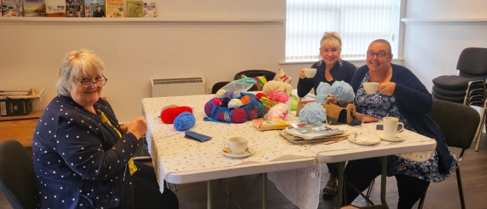 The group knitting, chatting and having a cuppa