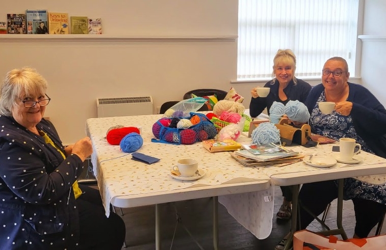 The group knitting, chatting and having a cuppa