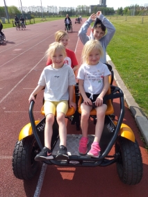 Young carers playing on a four man bike