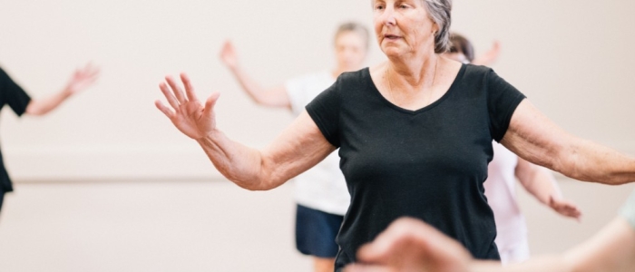 Woman dancing in a class and getting active and moving