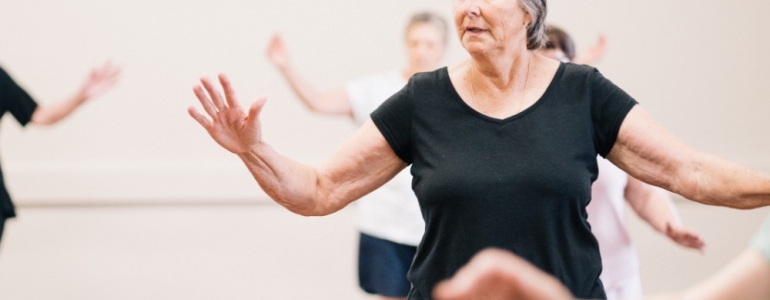 Woman dancing in a class and getting active and moving