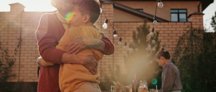 A grandmother hugging her grandson